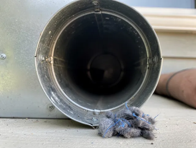 Medfield Dryer Vent Cleaning technician using specialized equipment to clear severe dryer vent blockage in Medfield